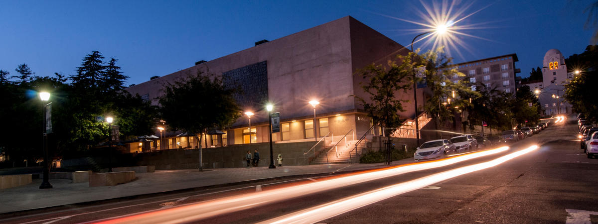 hero image: Bancroft Avenue night scene with long exposure of passing cars and International House in the distance